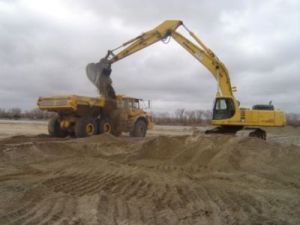 Photo of ESH construction using backhoe and truck